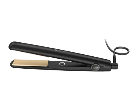 Black hair straightener with gold accents on a white background