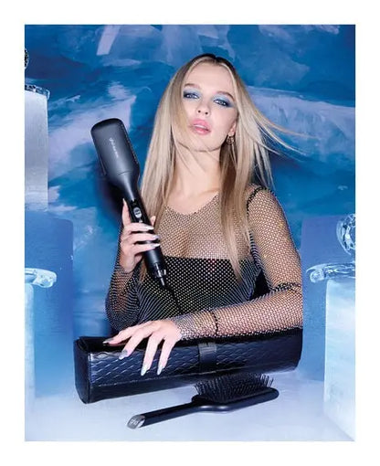 Woman holding a hair dryer with a blue and white abstract background