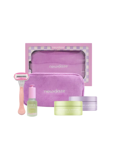 Skincare set with purple pouch, razors, and bottles on a white background