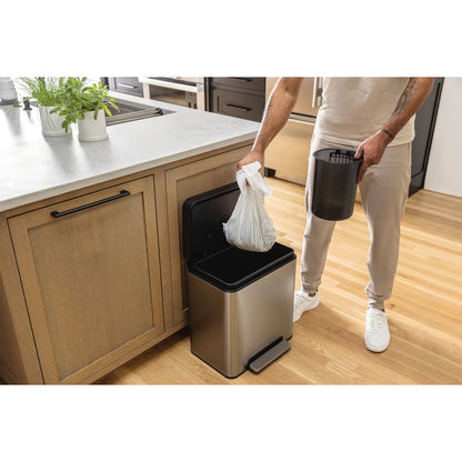 Person using a kitchen trash can with a liner in a home setting