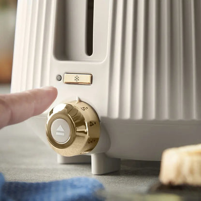 Hand adjusting a gold knob on a white radiator.