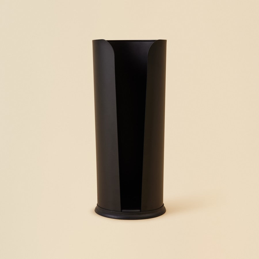 Black Cylindrical toilet paper holder against beige background
