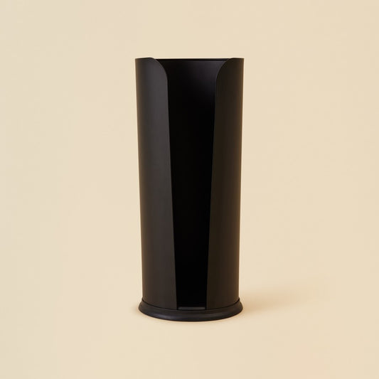 Black Cylindrical toilet paper holder against beige background
