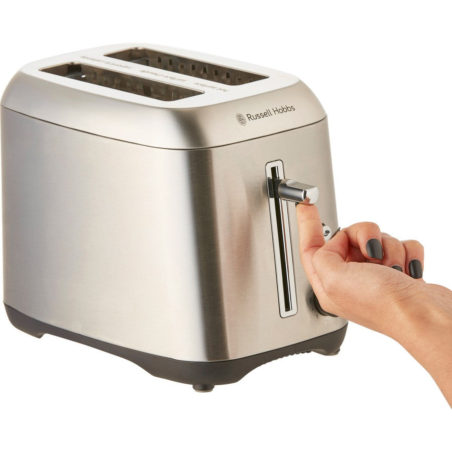 Silver Russell Hobbs toaster with a hand adjusting the control knob on a white background
