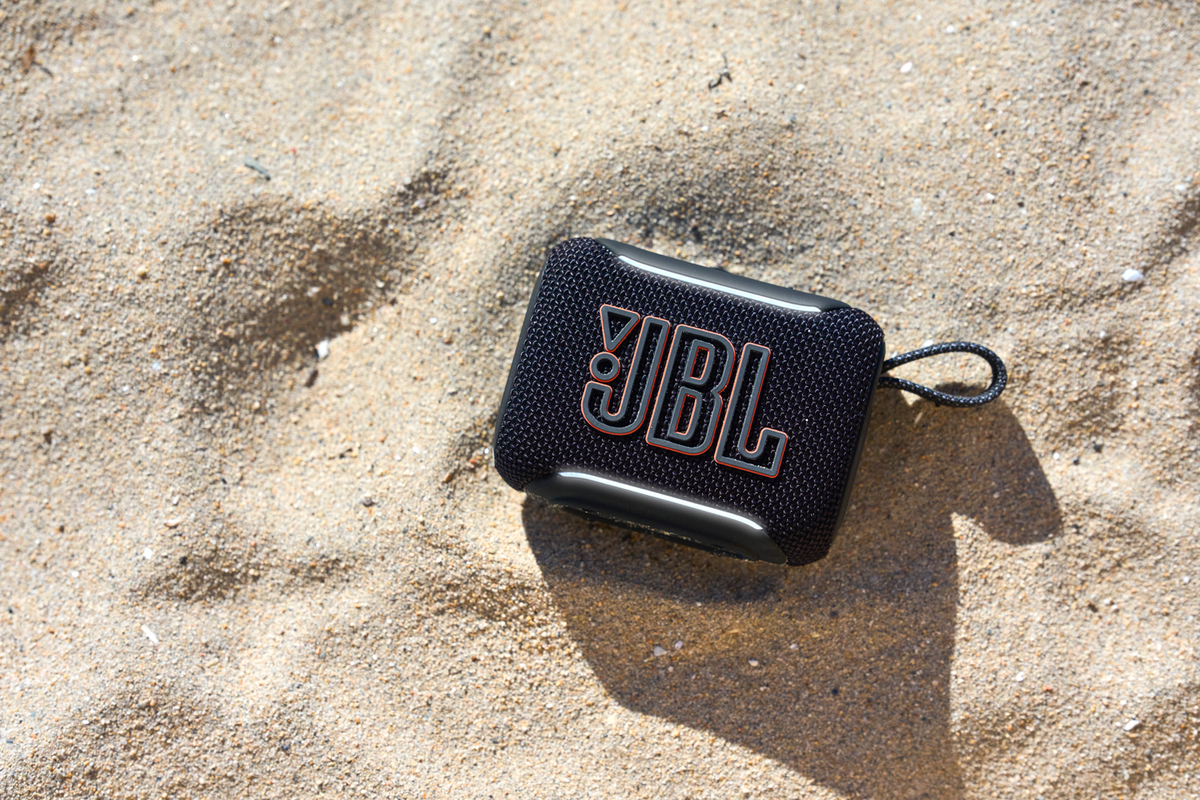 JBL Go 5 Mini speaker outdoors on sand