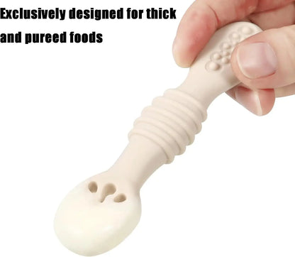 Silicone baby spoon held by a hand with text 'Exclusively designed for thick and pureed foods'.