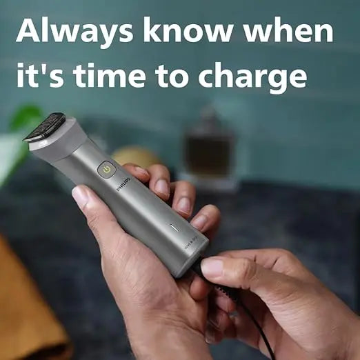 Person charging a silver electric shaver with text 'Always know when it's time to charge' on a blurred background.