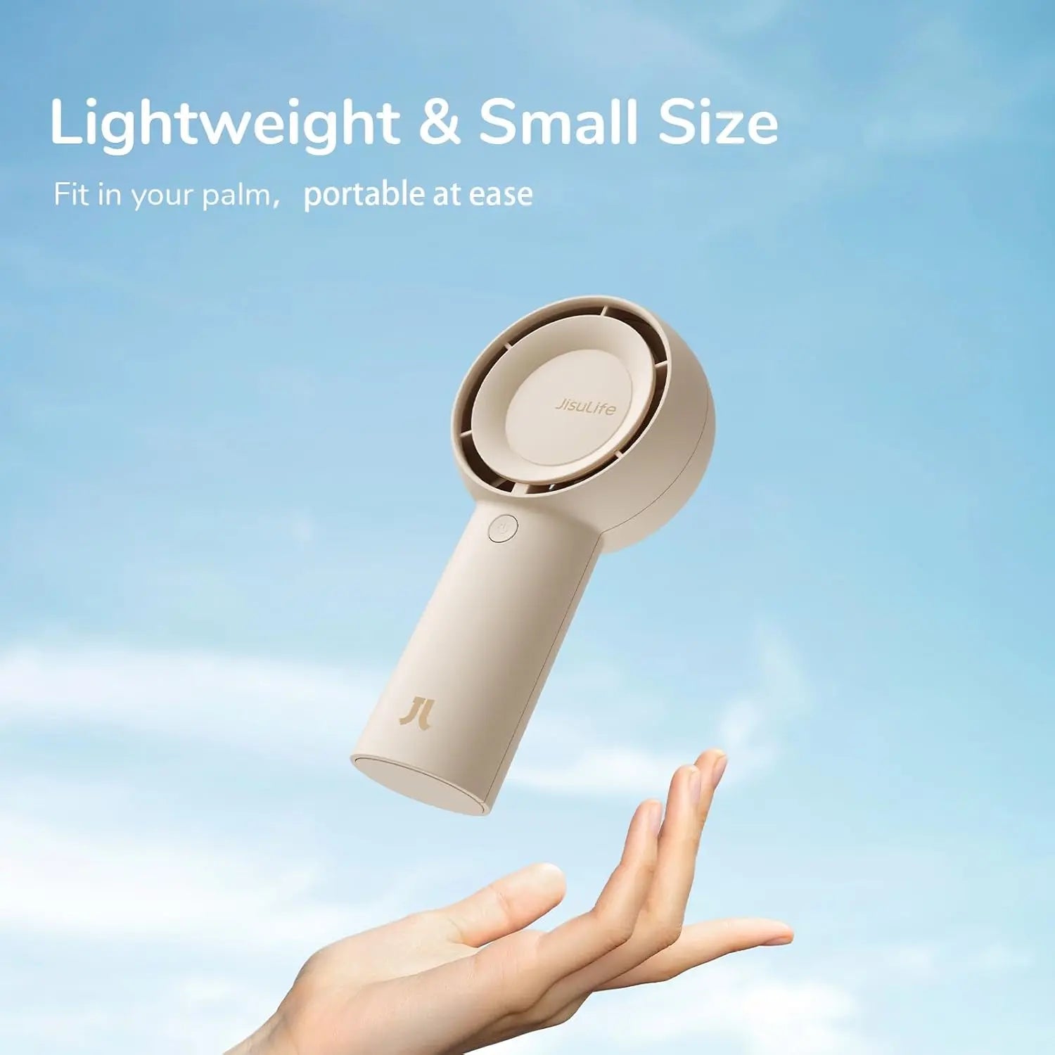 Handheld hair dryer held in a palm with a clear blue sky background
