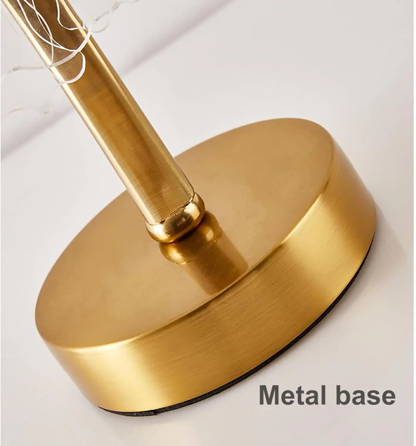Gold metal base of a lamp on a white background