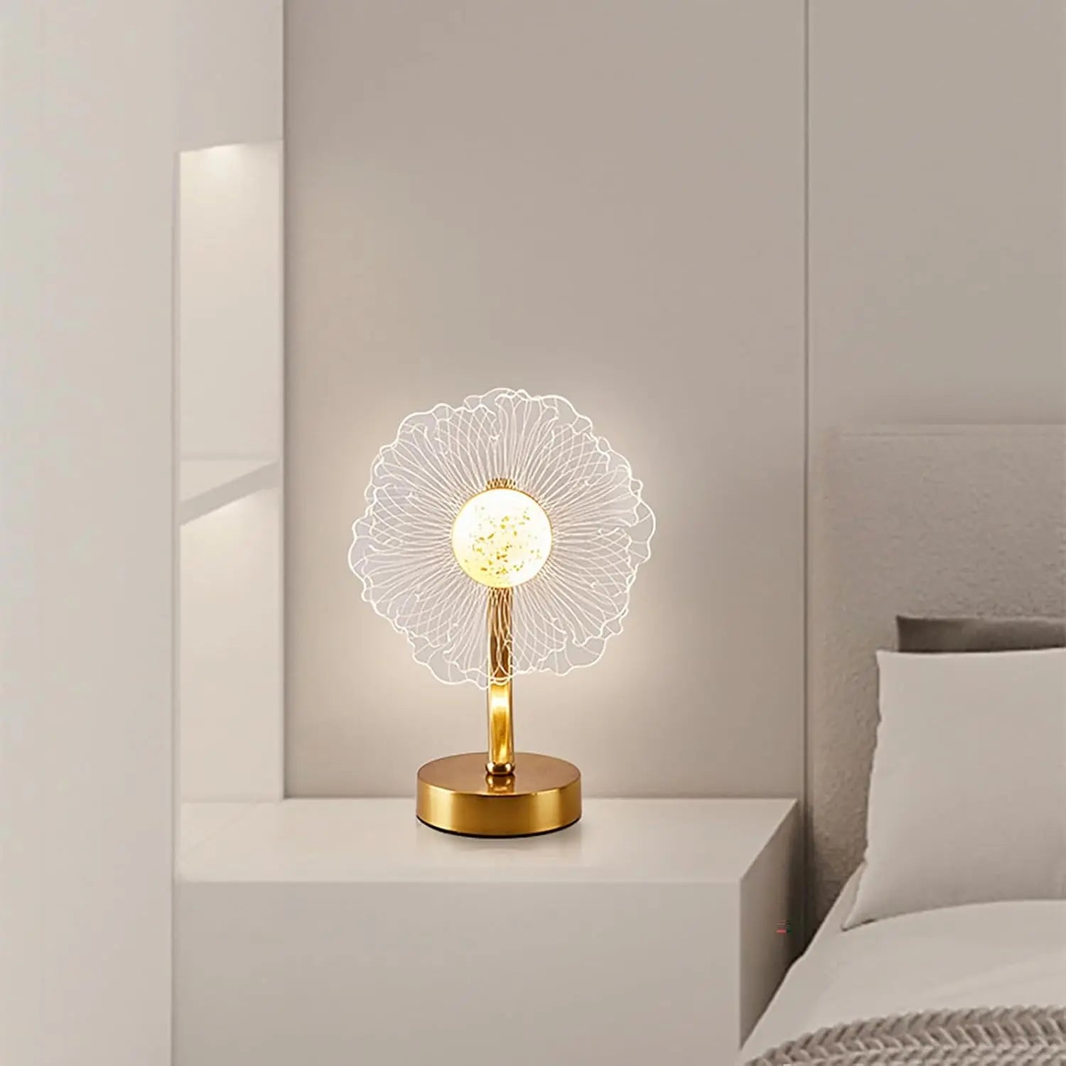 Decorative table lamp with floral design on a nightstand in a bedroom setting.