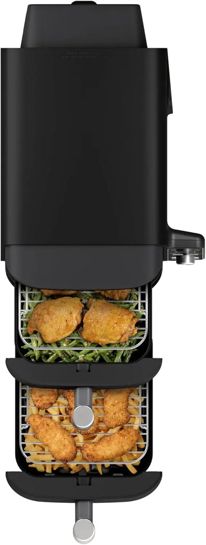Black deep fryer with food items on a white background