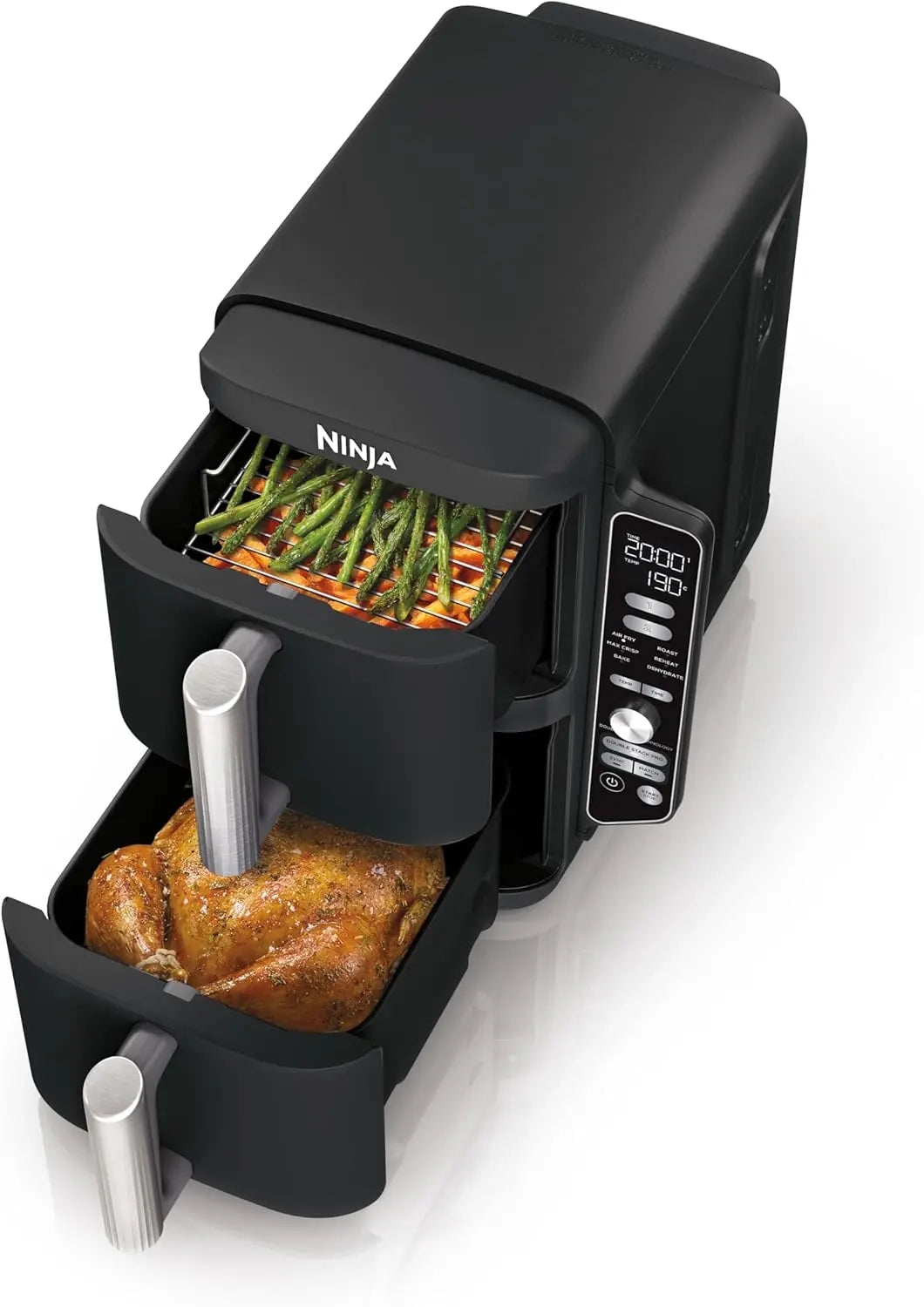 Ninja foodi multi-cooker with a roasted chicken and asparagus inside on a white background