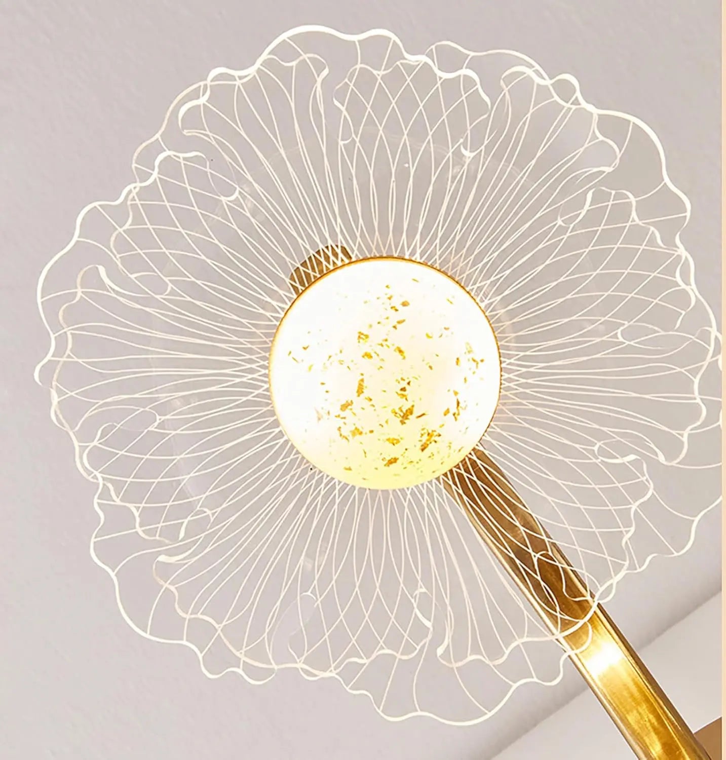 Decorative lamp with a gold leaf design on a light gray background