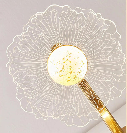 Decorative lamp with a gold leaf design on a light gray background