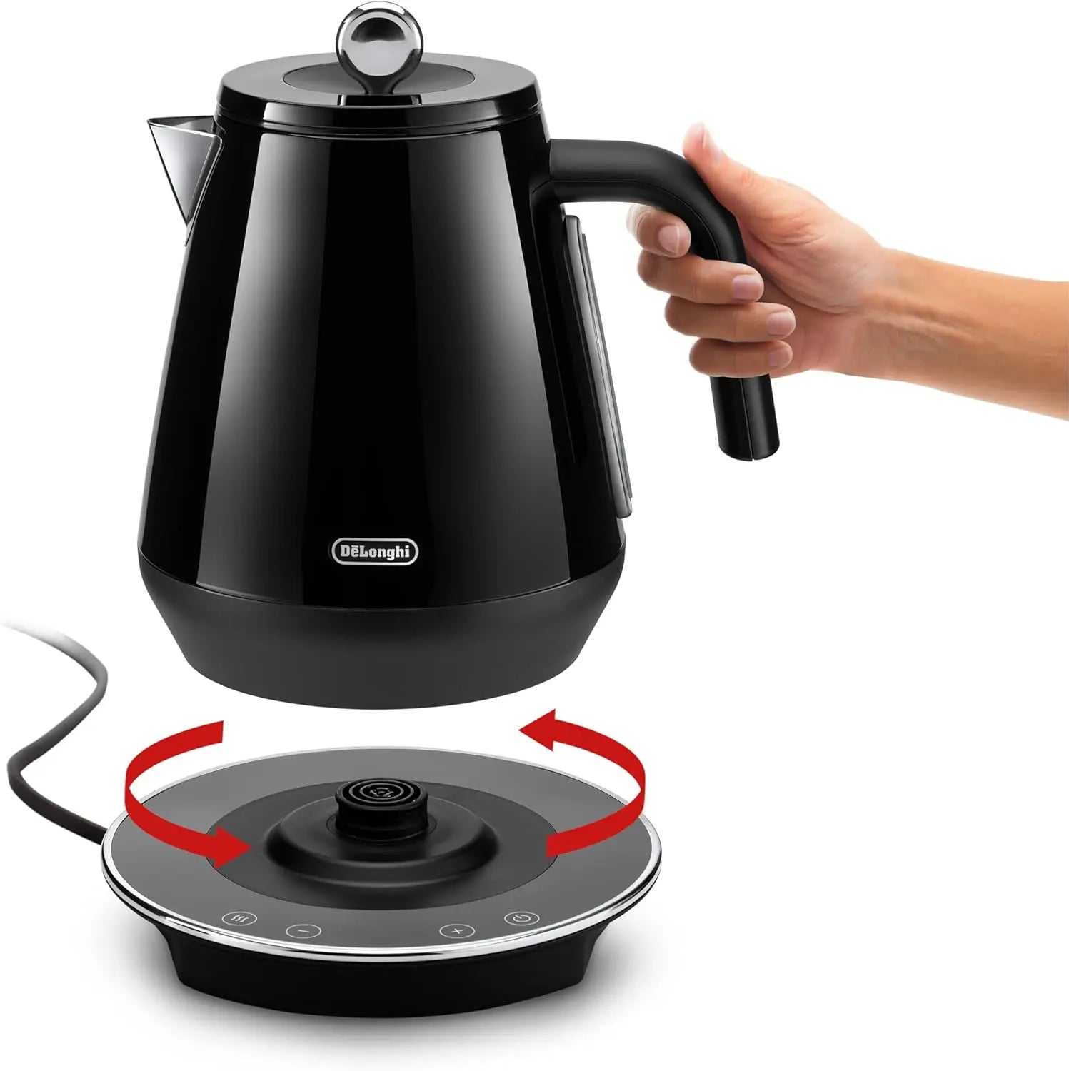 Black electric kettle being held above a matching base on a white background