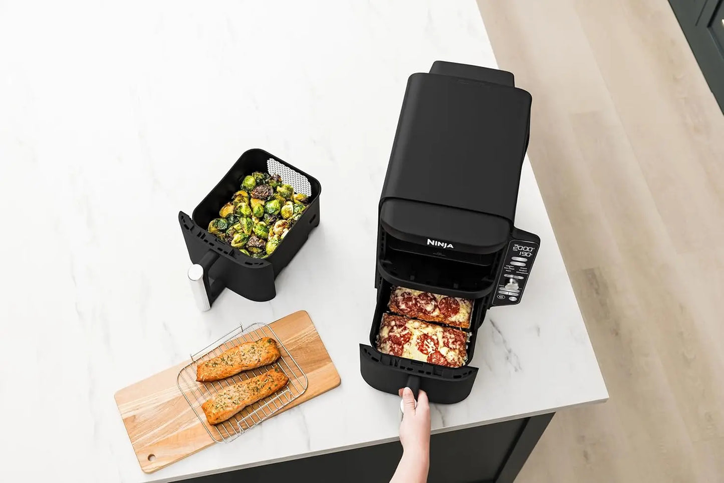 Ninja foodi appliance on a kitchen counter with food items around