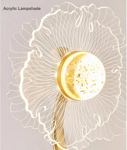 Acrylic lampshade with a gold base on a light gray background