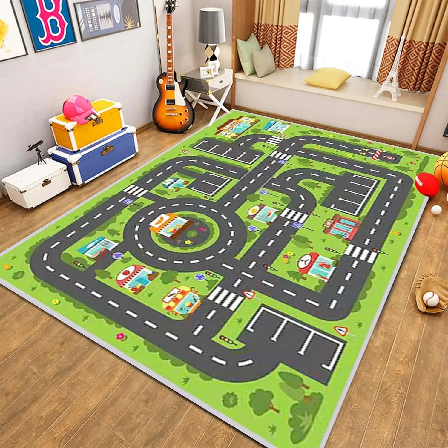 Play mat with road design on a wooden floor in a room with toys and furniture.