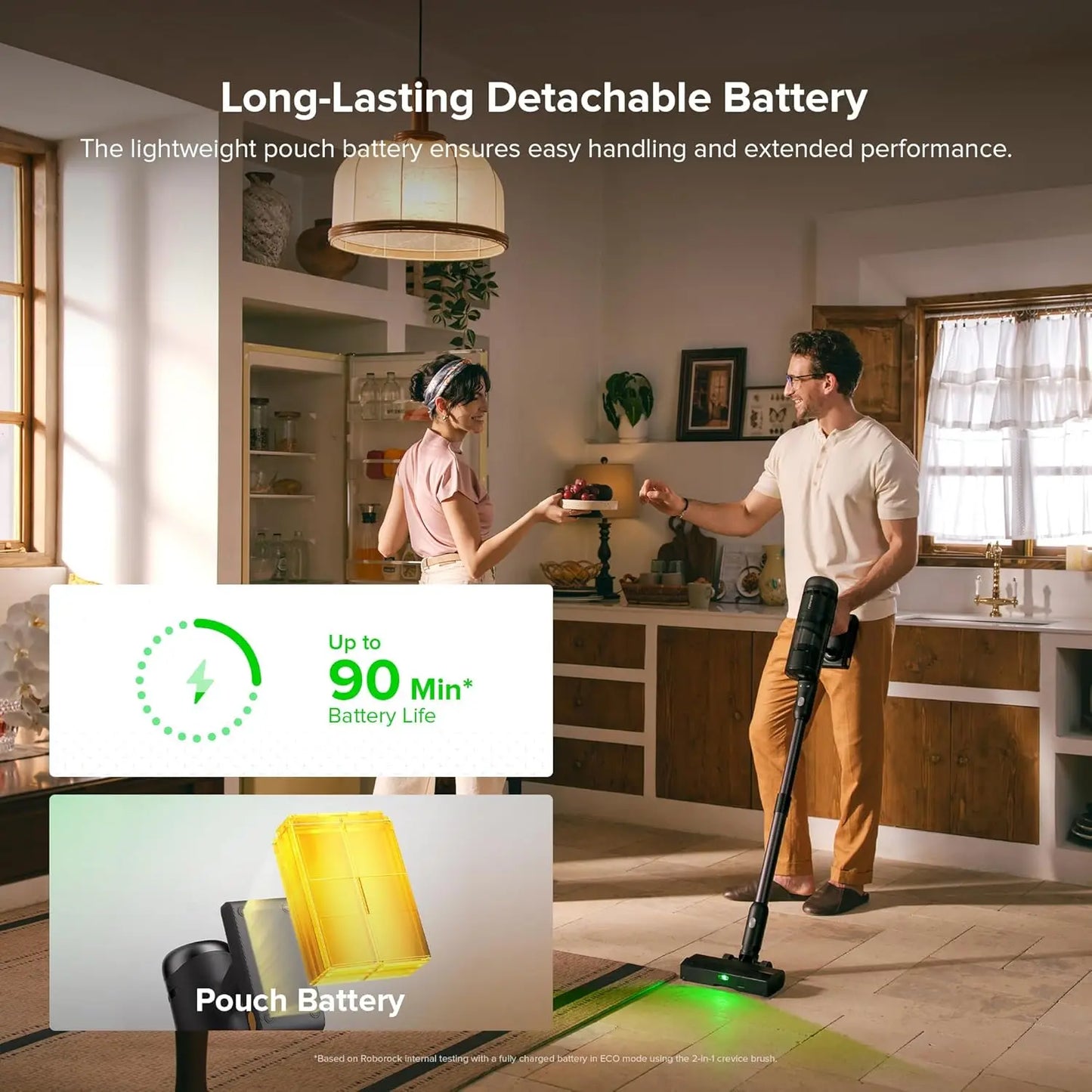 Man and woman in a kitchen with a vacuum cleaner and battery graphic, emphasizing long-lasting detachable battery.
