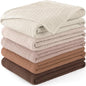 Stack of folded textured blankets in beige, brown, and pink on a white background