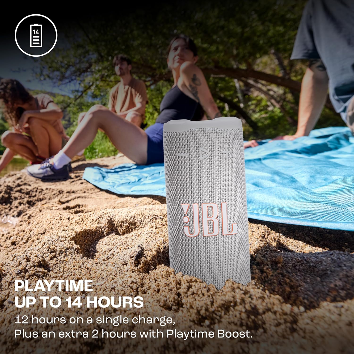 JBL speaker on sand with people in the background