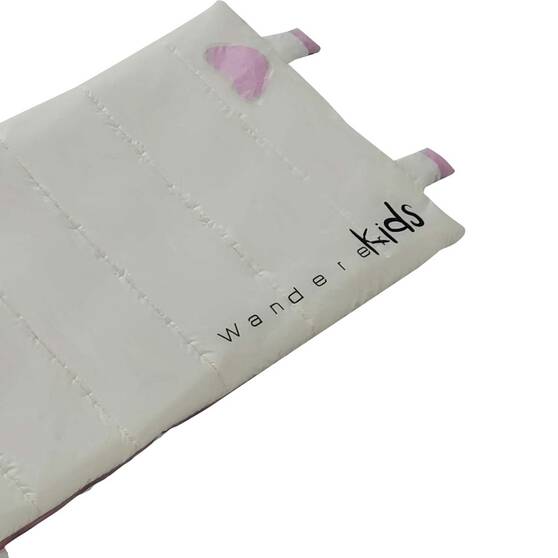A close-up of a white padded fabric item, likely a children's cushion or pad, with stitched channels, small pink tabs at the corners, and the text 'wander kids' printed in black.