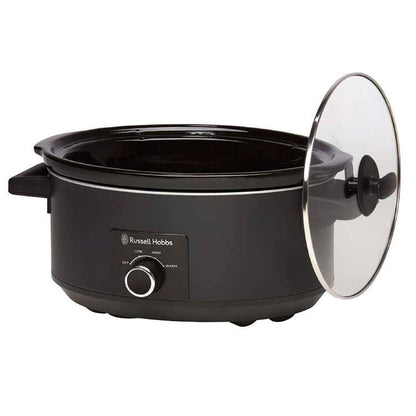 Black slow cooker with glass lid on a white background