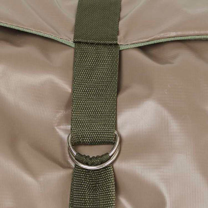 Close-up of a green strap with a metal ring on a beige fabric background