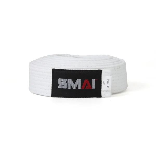 A white martial arts belt with a black label featuring the SMAI logo in gray and red, coiled on a white background.