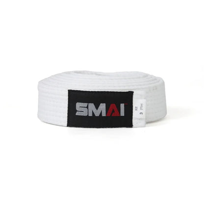 A white martial arts belt with a black label featuring the SMAI logo in gray and red, coiled on a white background.
