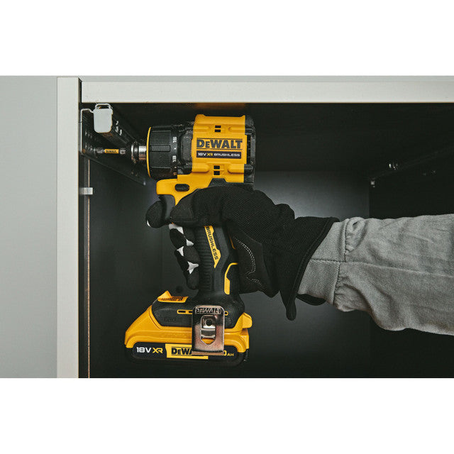 Hand holding a yellow and black DeWalt power tool against a gray background