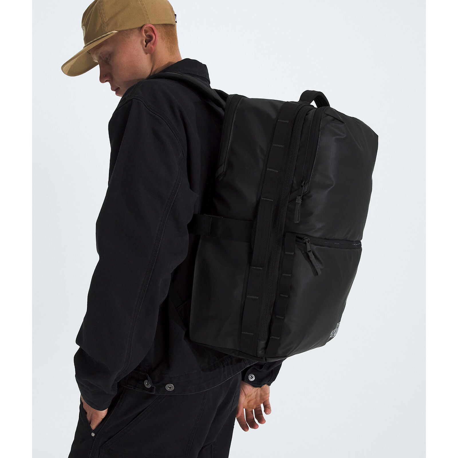 Person wearing a black backpack on a white background