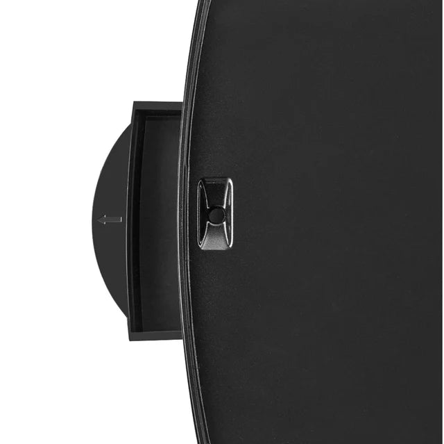 Close-up of a black wall-mounted clock with a metallic accent on a white background