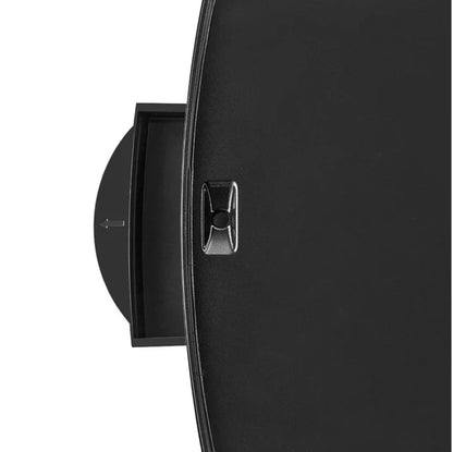 Close-up of a black wall-mounted clock with a metallic accent on a white background