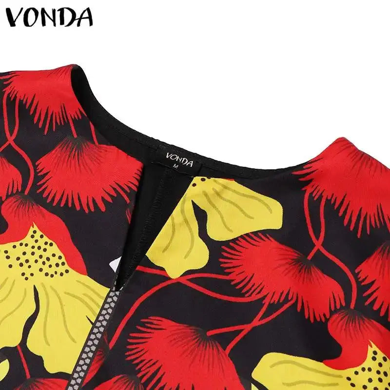 Close-up of a garment with red and yellow floral pattern on black background, brand 'Vonda' visible.