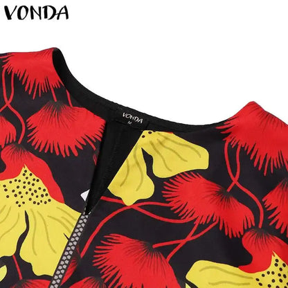 Close-up of a garment with red and yellow floral pattern on black background, brand 'Vonda' visible.