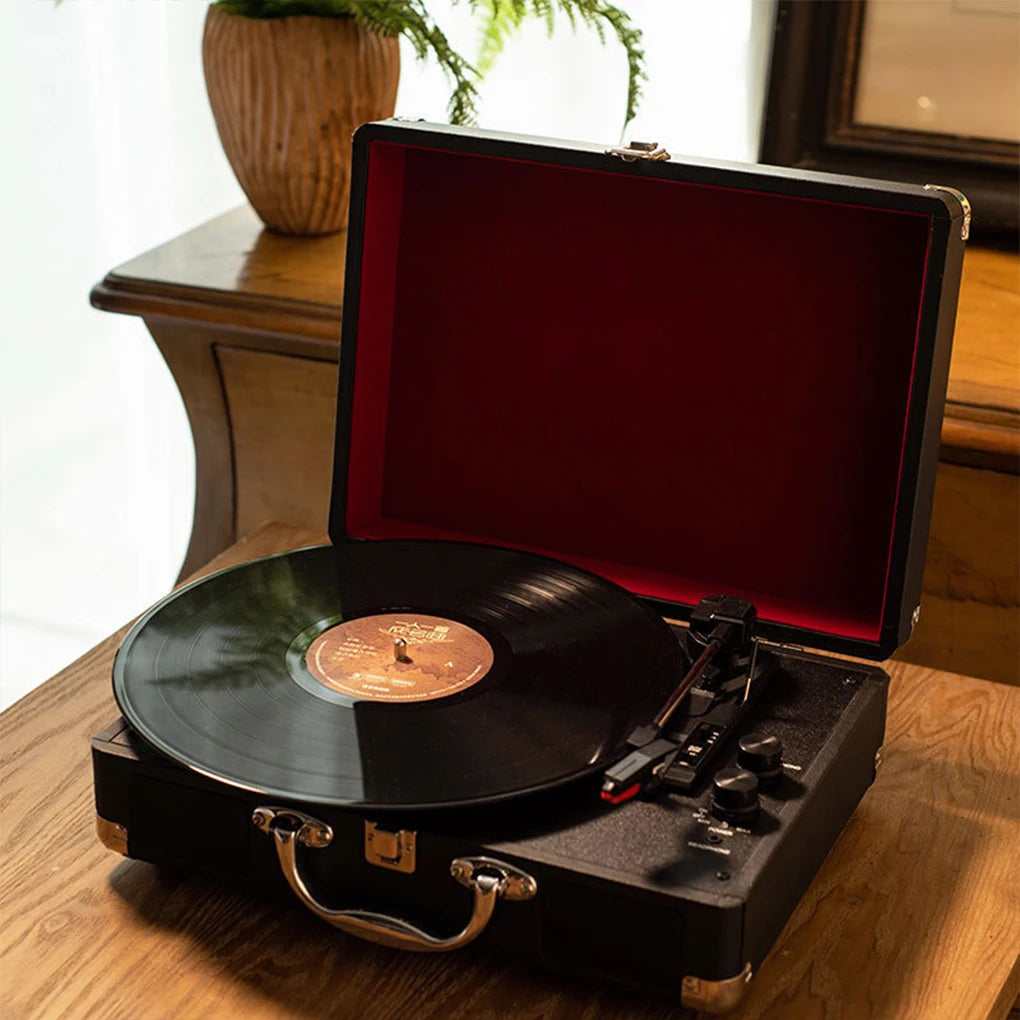 Loading a vinyl record onto the portable suitcase record player