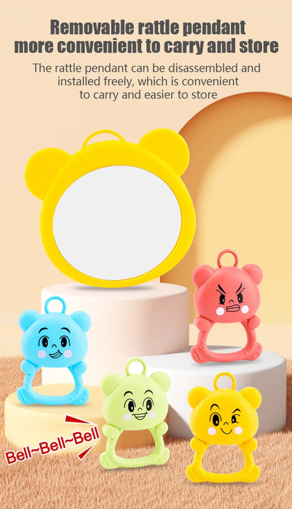 Colorful rattles with detachable pendants on a beige background