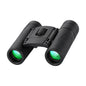 Black night vision binoculars with green lenses on a black background, labeled 'Shimmering Night Vision Armament Binoculars'.