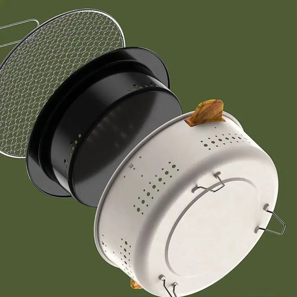 Collapsible metal strainer with black lid on a green background