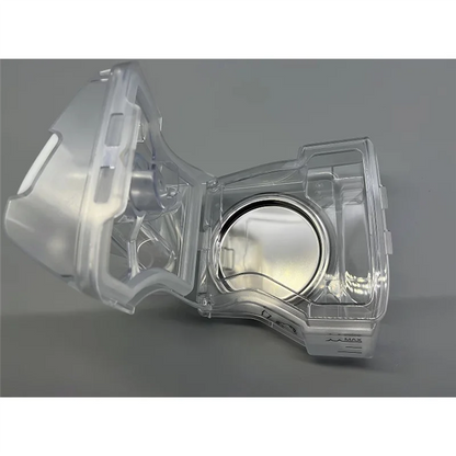 Clear plastic component on a gray background