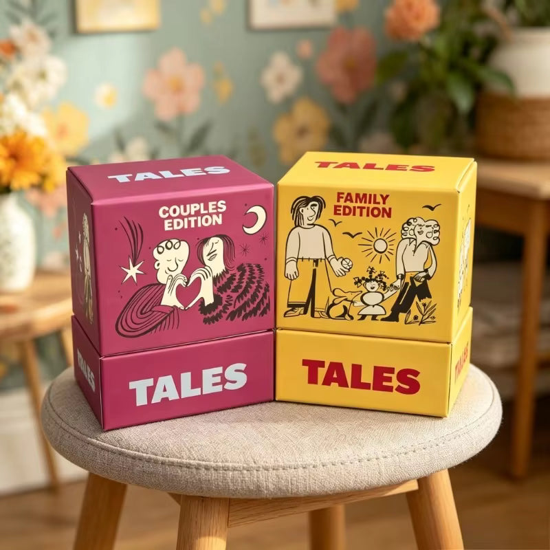 TALES Couples Edition and Family Edition boxes styled on a stool with floral decor in the background