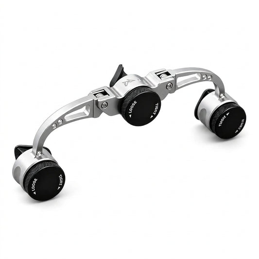 Metallic camera lens with adjustable dials on a stone surface