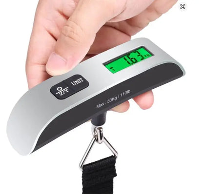 Digital luggage scale held by a hand with a white background