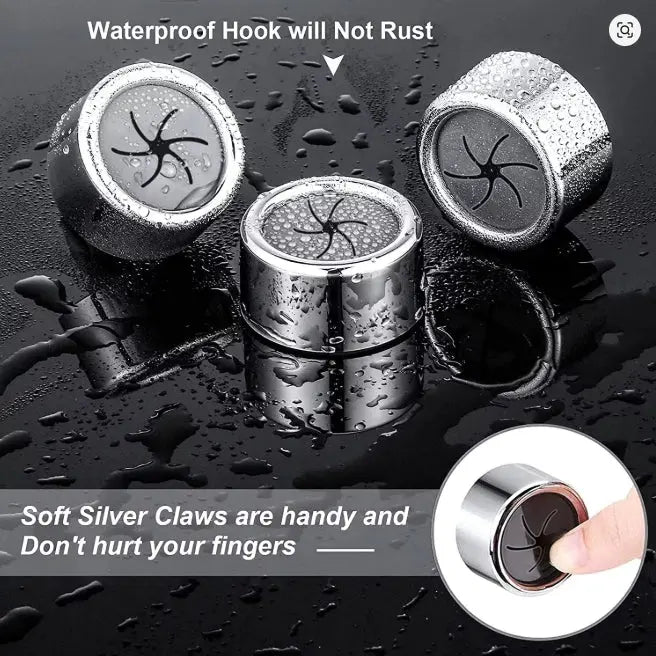 Three metallic hooks with soft silver claws on a dark surface with water droplets.