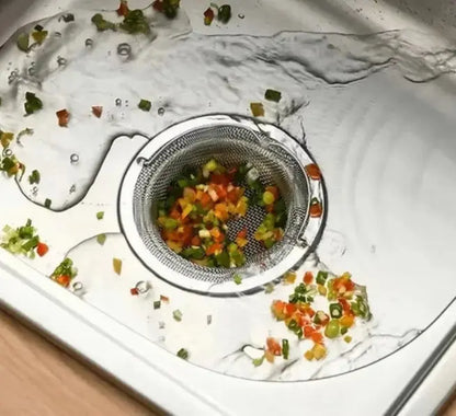 Drain with food scraps and a strainer in a sink
