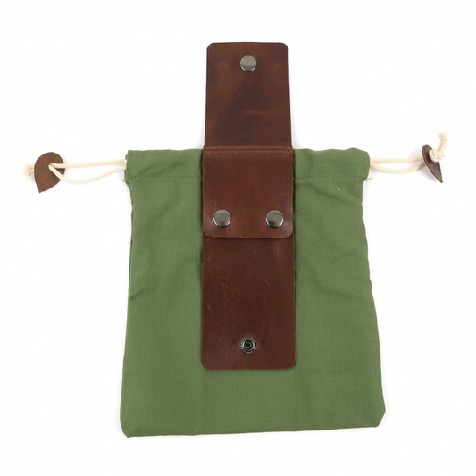An olive green canvas drawstring pouch with a brown leather strap closure secured by silver metal snaps, shown on a plain white background.