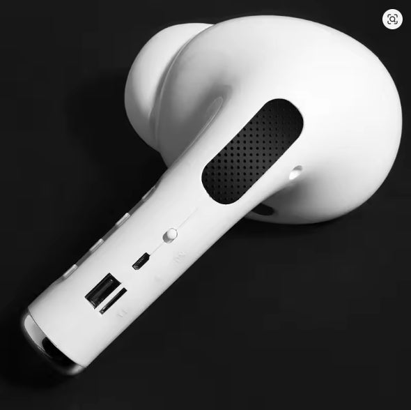 Close-up of a white wireless earbud on a black background