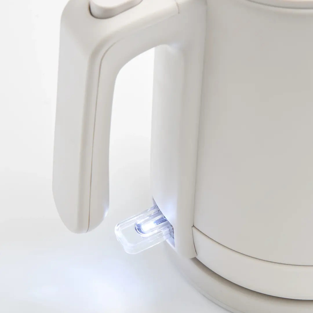 Close-up of a white electric kettle on a light gray background