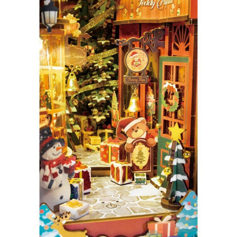 Christmas-themed diorama with teddy bears, snowmen, and decorative trees.